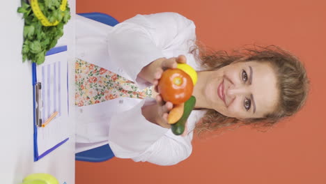 Vertical-video-of-Dietitian-doctor-holding-vegetables.-Healthy-life-message.